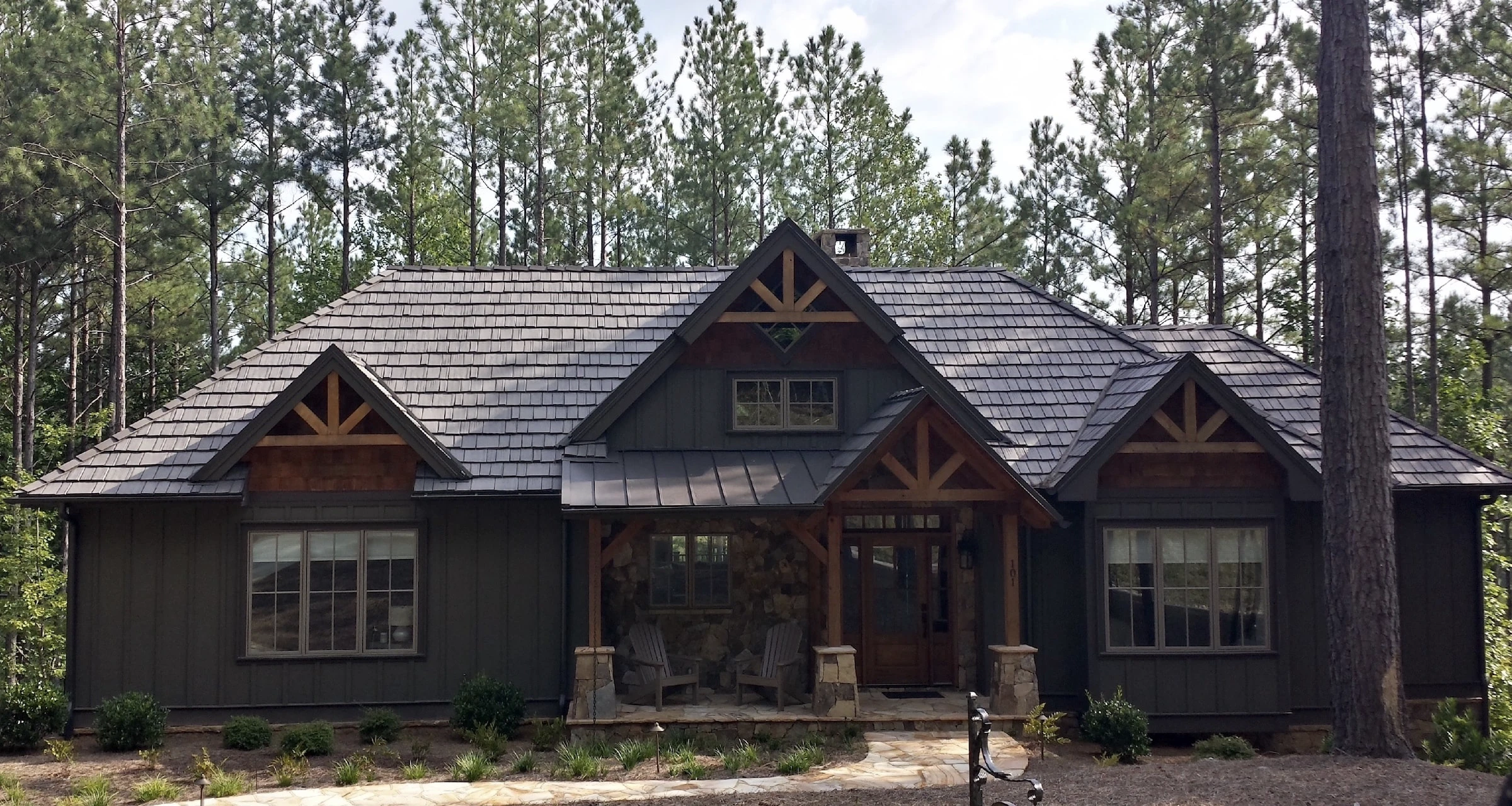 Residential house with DaVinci composite synthetic shake and standing seam metal roofing.