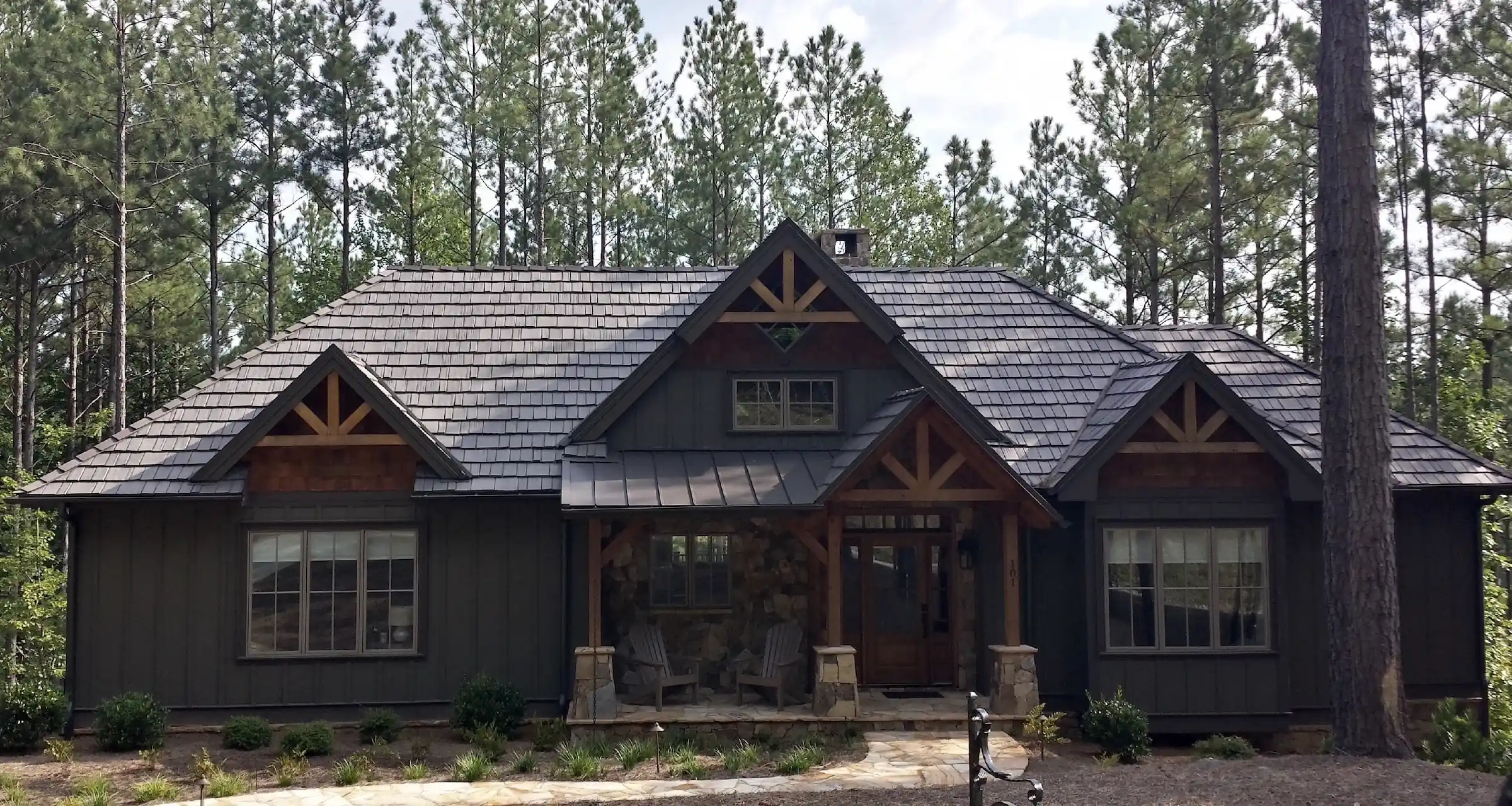 Residential house with DaVinci composite synthetic shake and standing seam metal roofing.